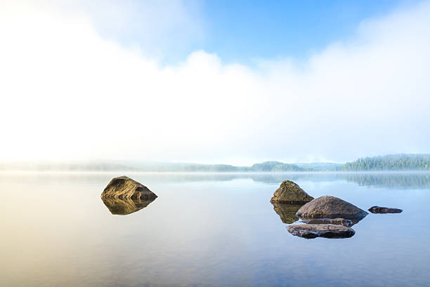 Early and harmonious morning with fog over the lake in northern Sweden